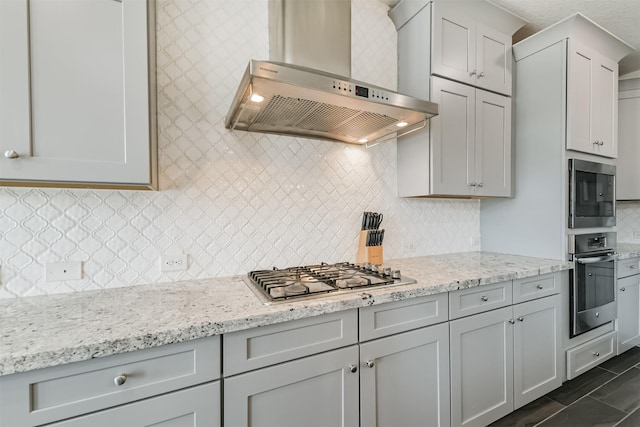 12107 Allington Cove Ln, Humble, TX 77346 - kitchen featuring backsplash, wall chimney exhaust hood, light stone counters, and stainless steel appliances