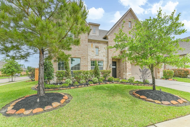 12107 Allington Cove Ln, Humble, TX 77346 - traditional home with brick siding, stone siding, a front yard, and concrete driveway