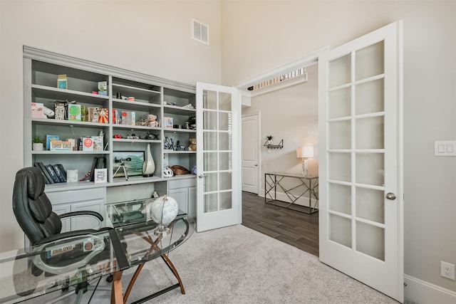 12107 Allington Cove Ln, Humble, TX 77346 - office area featuring wood finished floors, visible vents, french doors, baseboards, and carpet flooring