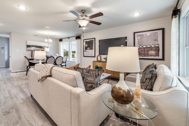 1200 Haverford Ln, Dayton, TX 77535 - living area with light wood-type flooring, baseboards, recessed lighting, and ceiling fan with notable chandelier