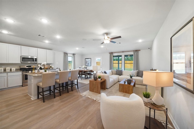 804 Timmons Ln, Dayton, TX 77535 - living area featuring a wealth of natural light, light wood-style floors, and recessed lighting