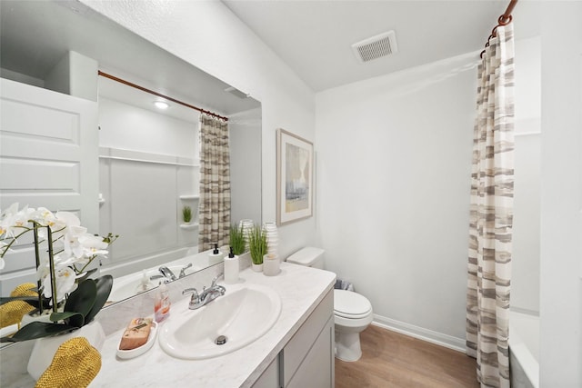 804 Timmons Ln, Dayton, TX 77535 - bathroom with toilet, baseboards, visible vents, wood finished floors, and vanity