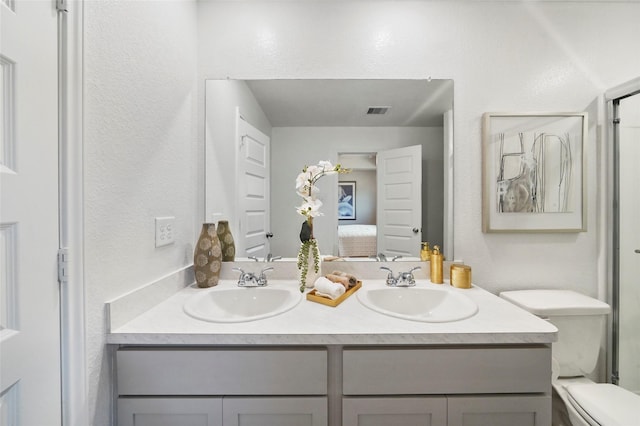 804 Timmons Ln, Dayton, TX 77535 - full bath with visible vents, connected bathroom, toilet, and a sink
