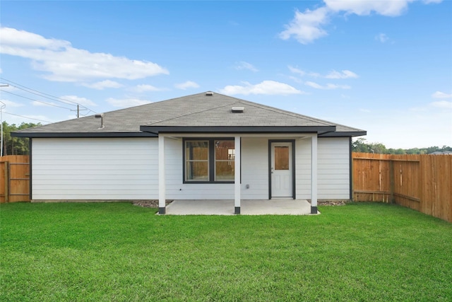 804 Timmons Ln, Dayton, TX 77535 - back of house featuring a fenced backyard, a yard, a patio area, and a shingled roof