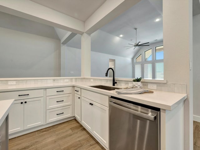 kitchen featuring light countertops, light wood-style floors, lofted ceiling, and dishwasher