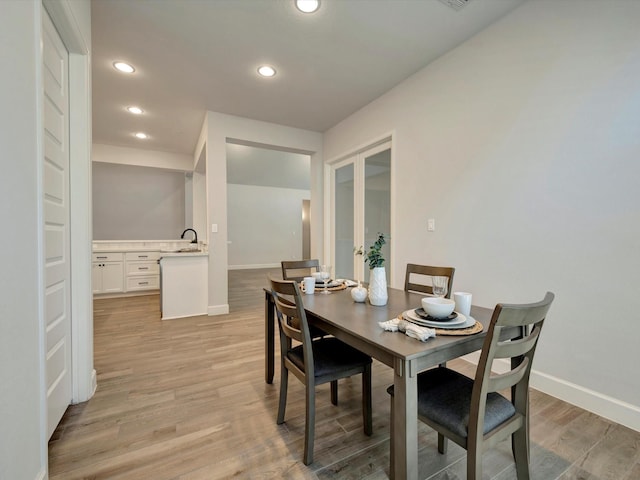 dining area with french doors, recessed lighting, baseboards, and light wood-style flooring