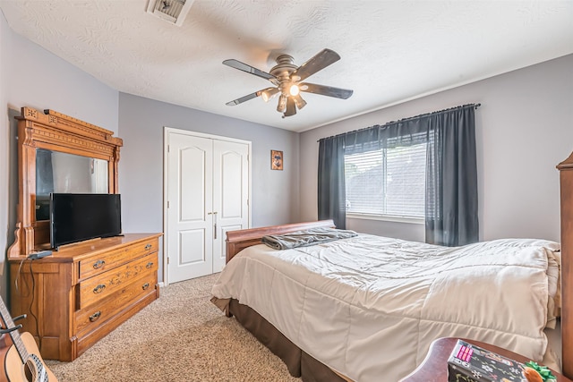 11906 Canyon Valley Dr, Tomball, TX 77377 - bedroom with a textured ceiling, visible vents, a closet, ceiling fan, and carpet floors