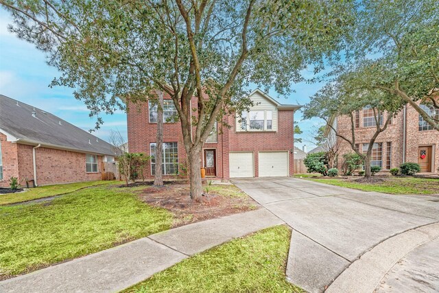 11906 Canyon Valley Dr, Tomball, TX 77377 - traditional home featuring a garage, driveway, a front lawn, and brick siding