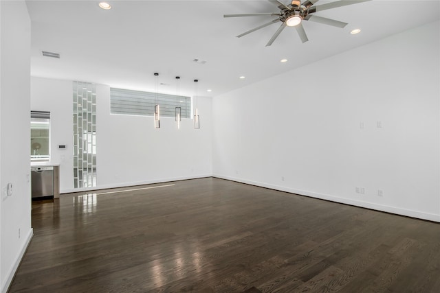 empty room featuring recessed lighting, ceiling fan, baseboards, and dark wood-style flooring