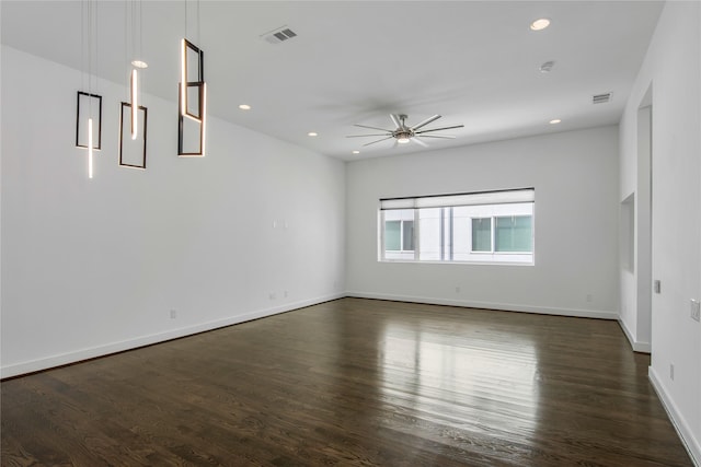 empty room featuring a ceiling fan, visible vents, recessed lighting, and dark wood-type flooring