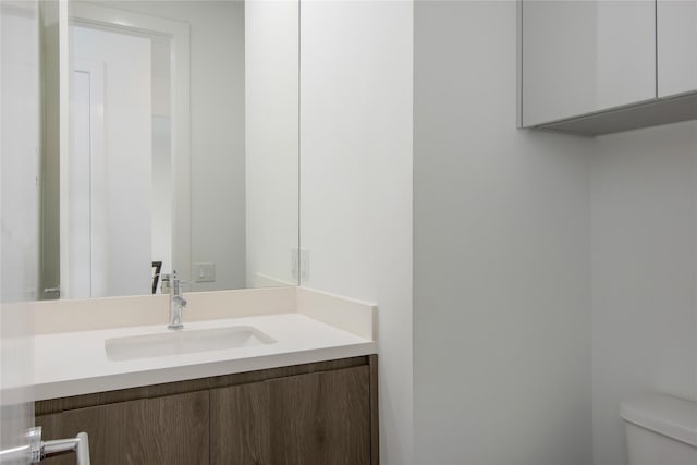 half bath featuring toilet and vanity