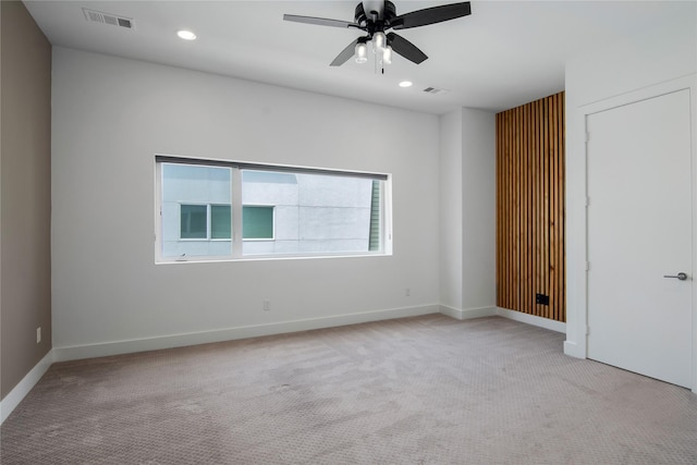 carpeted empty room featuring baseboards, a ceiling fan, visible vents, and recessed lighting