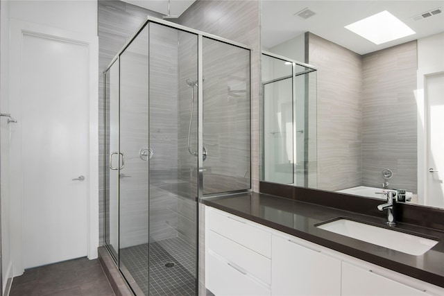 bathroom with a shower stall, visible vents, tile patterned flooring, and vanity