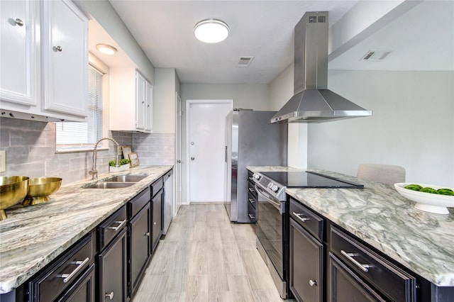 17434 Jolly Boat Dr, Crosby, TX 77532 - kitchen with range hood, appliances with stainless steel finishes, a sink, white cabinetry, and light stone countertops