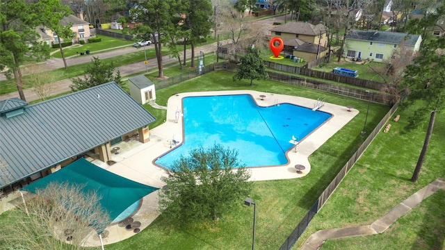 pool with a yard, fence, a patio area, and a residential view