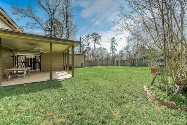 view of yard featuring a fenced backyard, a patio, and ceiling fan