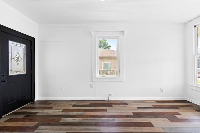 foyer with baseboards and wood finished floors