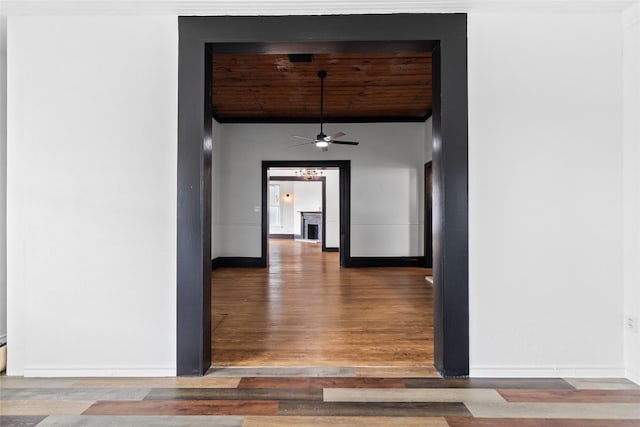 hall with wood finished floors and baseboards