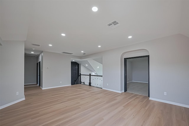 2006 Deer Vly, Missouri City, TX 77459 - empty room with visible vents, arched walkways, light wood-style flooring, and recessed lighting