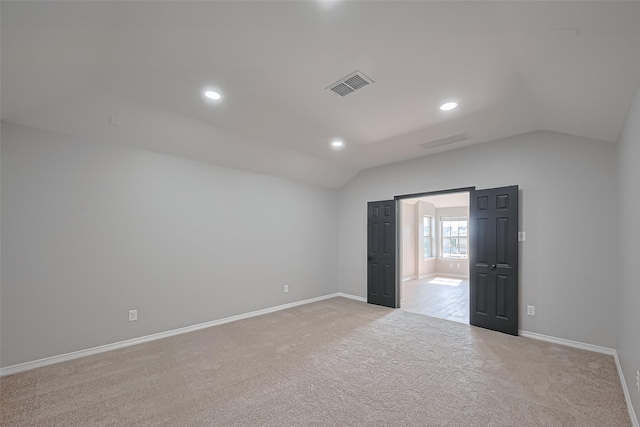 2006 Deer Vly, Missouri City, TX 77459 - spare room with baseboards, vaulted ceiling, light colored carpet, and visible vents