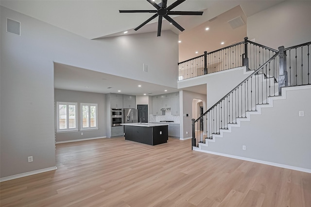 2006 Deer Vly, Missouri City, TX 77459 - unfurnished living room featuring arched walkways, ceiling fan, recessed lighting, and light wood-type flooring