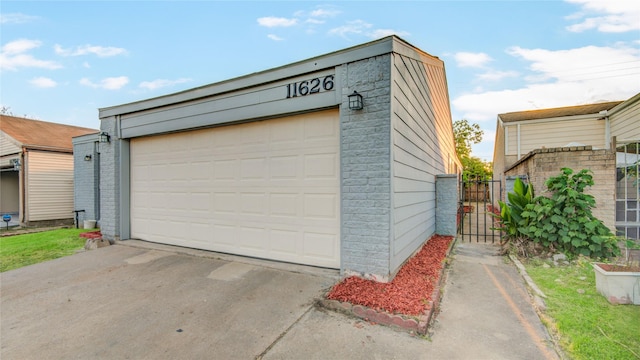 detached garage featuring a gate