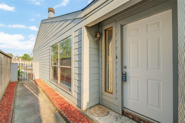 doorway to property featuring fence