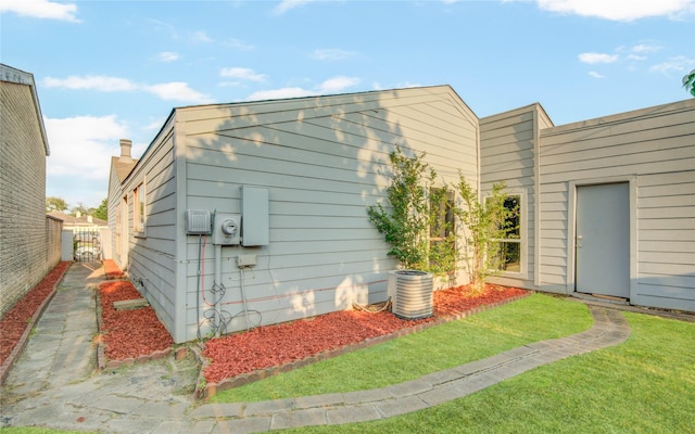 view of outbuilding with fence and central air condition unit