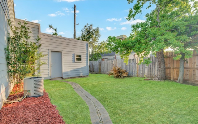view of yard featuring central air condition unit and fence