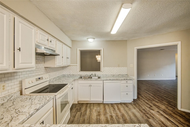 kitchen featuring a textured ceiling, white cabinetry, under cabinet range hood, wood finished floors, and white appliances