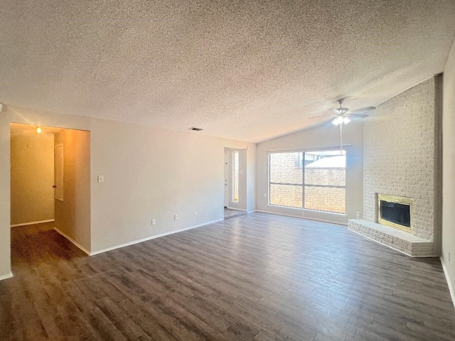unfurnished living room featuring lofted ceiling, a textured ceiling, a ceiling fan, and dark wood finished floors