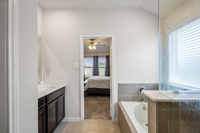 ensuite bathroom featuring tile patterned flooring, a ceiling fan, vanity, ensuite bath, and a garden tub