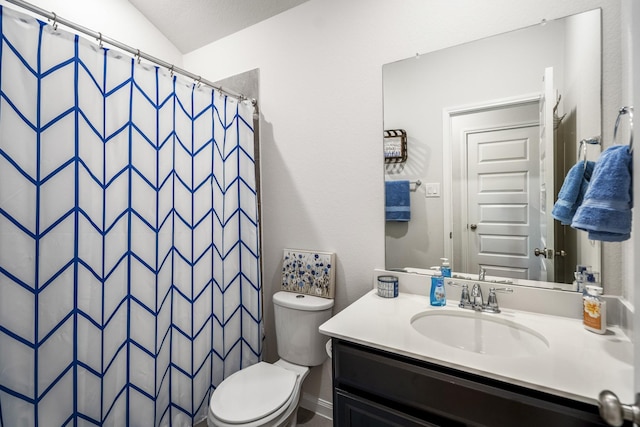 bathroom with toilet, vanity, and a shower with curtain