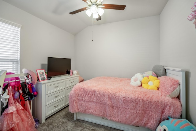 carpeted bedroom with vaulted ceiling and a ceiling fan