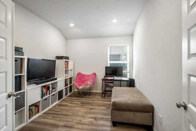 living area with baseboards, vaulted ceiling, wood finished floors, and recessed lighting