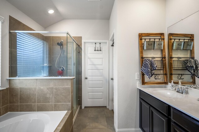 full bathroom with a bath, vaulted ceiling, tile patterned flooring, a shower stall, and vanity