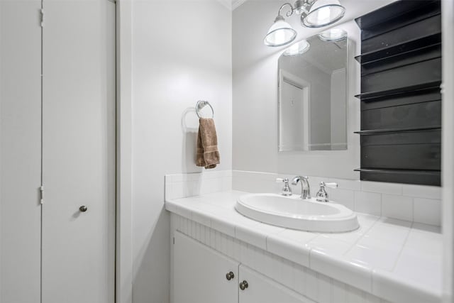 bathroom with vanity and ornamental molding