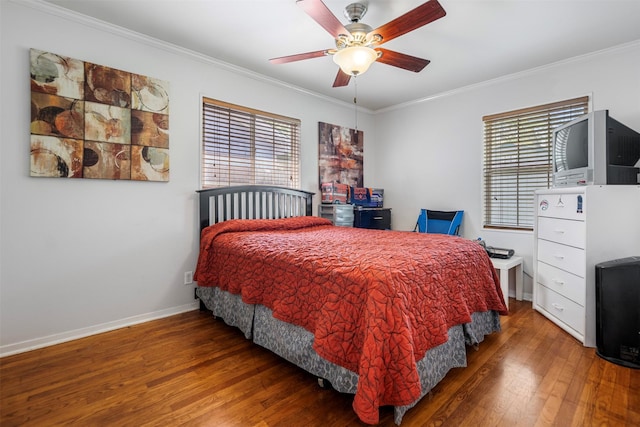 bedroom with ornamental molding, wood finished floors, and multiple windows