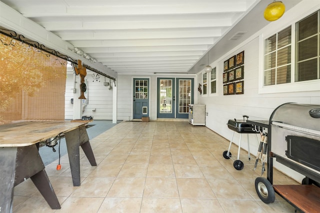 sunroom / solarium featuring french doors