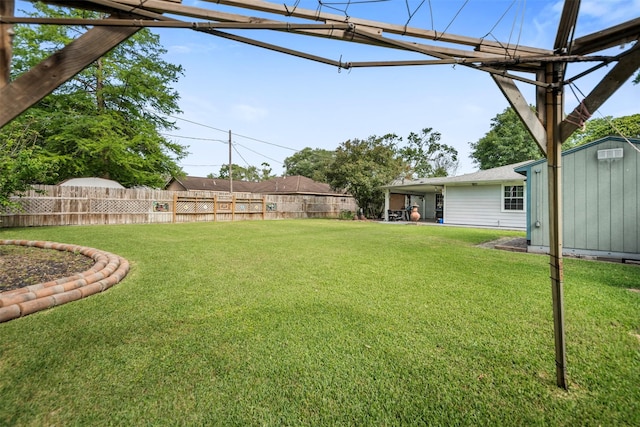 view of yard featuring fence, an outdoor structure, and a shed