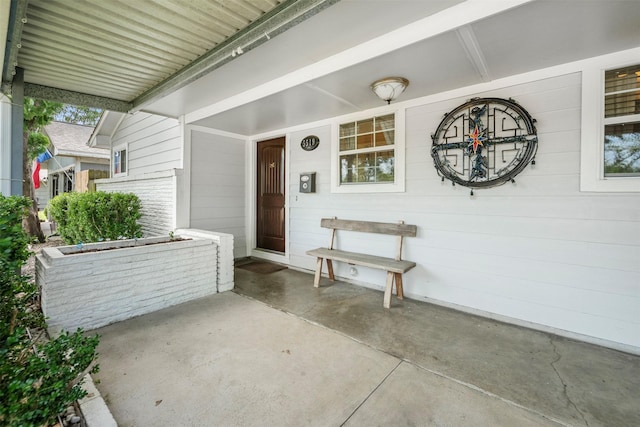 doorway to property featuring covered porch