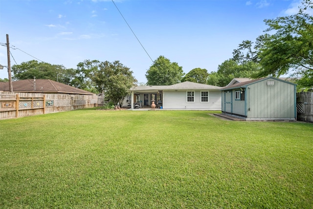 rear view of property featuring a fenced backyard, an outbuilding, a yard, and a storage shed