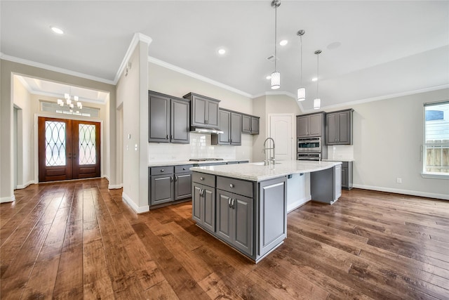 29167 Turning Springs Ln, Fulshear, TX 77441 - kitchen with a sink, stainless steel gas stovetop, a chandelier, backsplash, and gray cabinetry