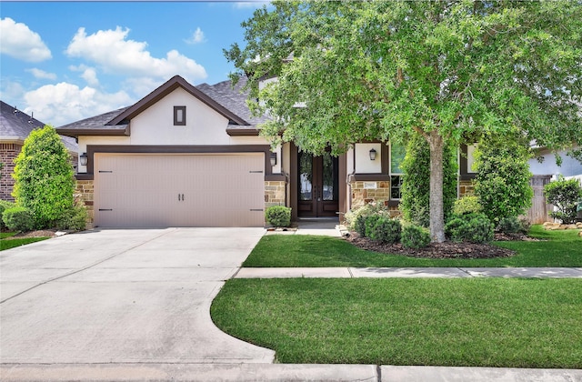 29167 Turning Springs Ln, Fulshear, TX 77441 - view of front of house with stucco siding, concrete driveway, stone siding, a front yard, and a garage