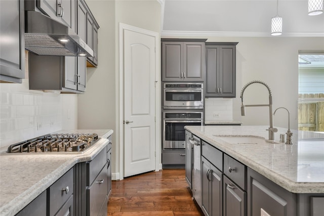 29167 Turning Springs Ln, Fulshear, TX 77441 - kitchen featuring a sink, dark wood-style flooring, decorative backsplash, under cabinet range hood, and appliances with stainless steel finishes