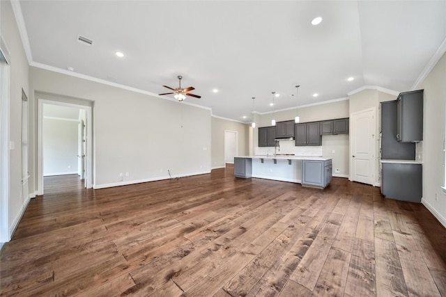 29167 Turning Springs Ln, Fulshear, TX 77441 - unfurnished living room featuring crown molding, ceiling fan, dark wood-style flooring, visible vents, and recessed lighting