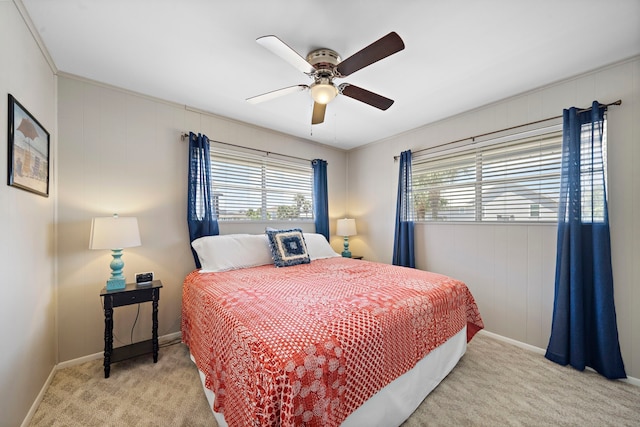 carpeted bedroom featuring baseboards and ceiling fan