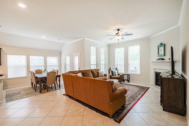 living room featuring a healthy amount of sunlight, crown molding, and light tile patterned floors