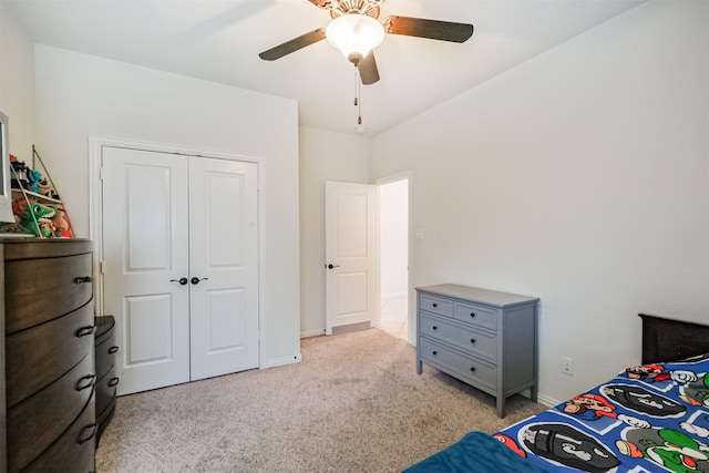 bedroom featuring light colored carpet, baseboards, a ceiling fan, and a closet