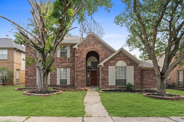 15306 Goodman St, Houston, TX 77084 - view of front of property with brick siding, a front lawn, and roof with shingles